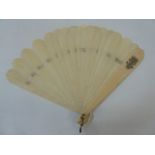 A late 19th century ivory brise fan, plain form with curved edges, the guards monogrammed with