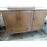 Ercol blonde elm sideboard having double doored cupboard with single drawer below and further single