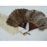 Two ostrich feather and tortoiseshell fans and a white ostrich feather fan with ivory handle (3)