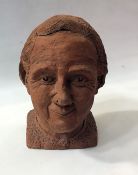 Terracotta head sculpture of an older woman, 27cm high