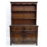 20th century oak dresser, the moulded cornice above open shelves, a base of two drawers and two