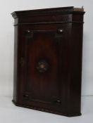 20th century oak wall hanging corner cupboard, the moulded cornice above single door with moulded