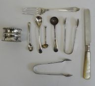 Silver napkin ring, a small silver tea fork, two silver sugar nips, miniature spoons and a mother-