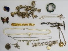 Silver charm bracelet, costume rings, silver chains, beaded necklaces, brooches in a jewellery box