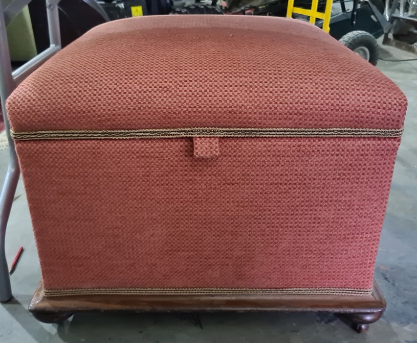 Late 19th century ottoman in pink ground upholstery, mahogany base on squat bun feet and castors
