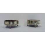 Pair of early 20th century silver and blue glass circular salts with pierced decoration,