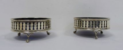 Pair of early 20th century silver and blue glass circular salts with pierced decoration,