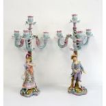 Pair of 19th century porcelain candelabra, four-branch, floral encrusted with male and female