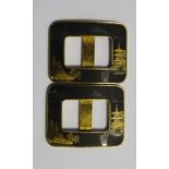A pair of Japanese niello buckles, c.1930, in gold and black with mountain and pagoda scenes, mark
