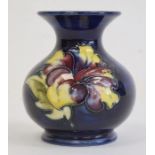 Moorcroft pottery miniature squat vase in hibiscus pattern, on blue ground, 9cm high