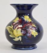 Moorcroft pottery miniature squat vase in hibiscus pattern, on blue ground, 9cm high