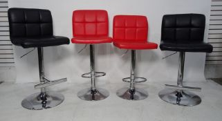 Four modern leather upholstered bar stools, two in black, two in red (4) and a Samsonite suit