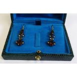 Ornate garnet and diamond drop earrings, boxed