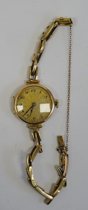 Gold-coloured lady's wristwatch with Arabic numerals to the dial