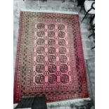 Persian rug with 21 elephant foot guls to the red ground field, stepped border, 270cm x 195cm