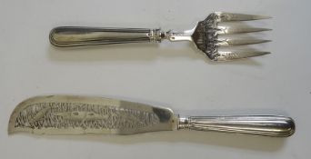 Pair of Victorian silver fish servers, pierced decoration and decorated with fish among reeds,