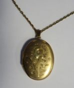 9ct gold oval locket, floral engraved decoration, on 9ct gold chain, 10.6g in total