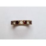 Gold-coloured metal, diamond and garnet eternity ring