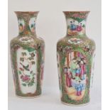 Pair of Chinese Canton baluster vases, each painted in a typical palette with figures on terracing