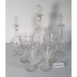 A set of six Waterford cut glass wines, three various decanters, and various other cut glass wines