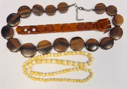 19th century ivory-effect graduated beads, a rosewood carved beaded necklace and an amber-effect