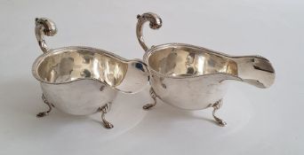 Pair of Edward VIII silver sauce boats on splayed feet, with egg and dart decoration to rim,