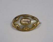 Victorian gold coloured and metal mounted mother of pearl and pink stone oval shaped brooch with
