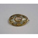 Victorian gold coloured and metal mounted mother of pearl and pink stone oval shaped brooch with