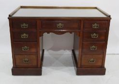 Late 19th century mahogany desk with three-quarter gallery to top, moulded front edge above nine