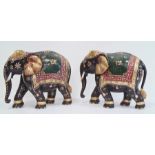 Pair of carved and decorated elephants, gilt highlighted, 26.5cm high (2)