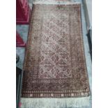 Eastern rug, the central field with hooked diamond medallions, stepped border, 185cm x 100cm approx