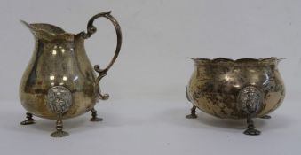 1920's Mappin & Webb silver milk jug and sugar bowl, both with mask decorated feet, London 1927, 6.