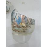 Two Chinese painted glass snuff bottles and two glass covers, the largest painted with buildings and