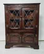 20th century oak corner cupboard with leaded glazed doors above two cupboard doors, bracket feet