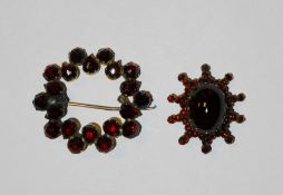 Cabochon garnet set star shaped brooch and another garnet circular brooch (2)