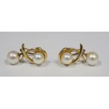 Pair of 14ct gold and pearl earrings, each with single pearl and crossover design and having pearl