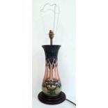 Moorcroft pottery table lamp, squat baluster-shaped and having tube-lined hibiscus decoration,