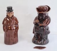 Treacle glazed Toby jug and a pottery figure decanter (2)