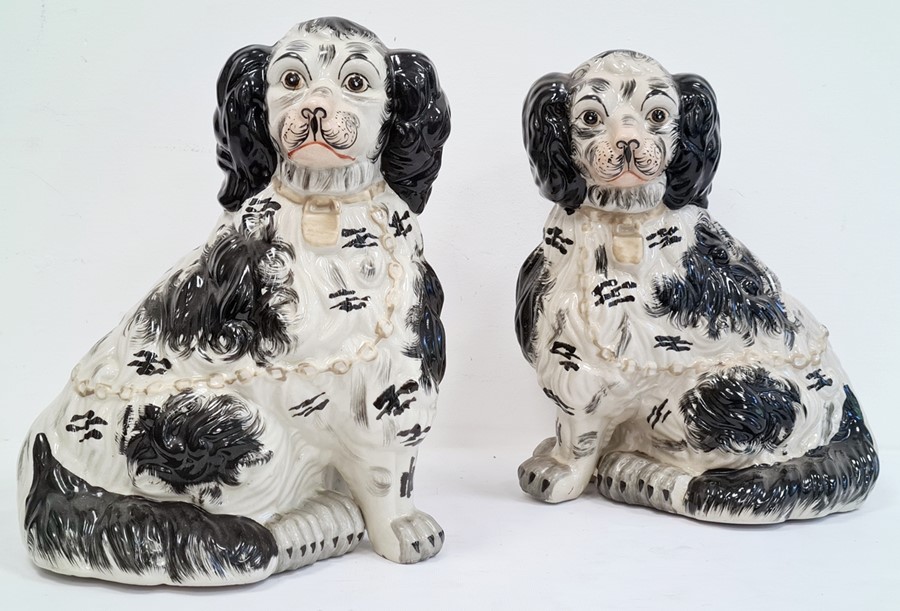 Pair of pottery Staffordshire-type model spaniels in black and white, 35cm high (2)