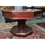 19th century mahogany octagonal-topped rent table, the plain edge above four drawers, on a single