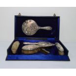 George V silver dressing table set viz:- hand mirror, pair hair brushes, pair clothes brushes and