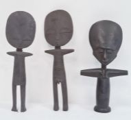 Two carved African figures with large oval flat faces and a similarly carved female figure (3)