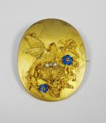 Victorian gold-coloured oval brooch/pendant with relief of bird and nest, with enamelled flowers and