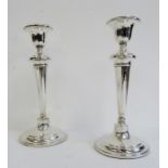 Pair of early 20th century silver-mounted candlesticks, tapering, on circular base, Birmingham,