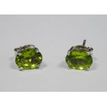 Pair of silver stud earrings set with peridots