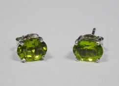 Pair of silver stud earrings set with peridots