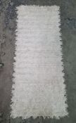 Cream ground rug with striped decoration and another rug (2)