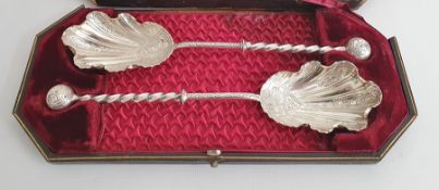 A cased set of silver-coloured metal ornate serving spoons, with ball finials, twist stems, engraved