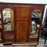 19th century mahogany three-door wardrobe with ogee moulded cornice above panelled central and