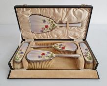 1930's silver and enamel mounted dressing set comprising of four brushes and mirror, cased, the pale